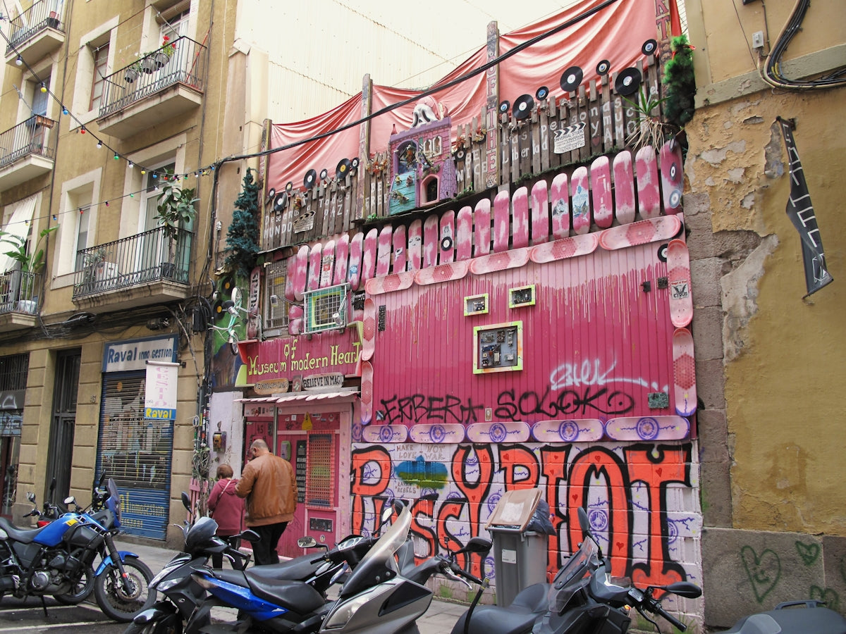 Pink building facade with graffiti and skateboards